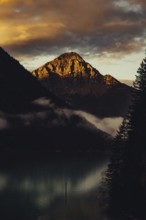 Sunrise with reflections and alpenglow in Lake Heiterwanger See in Tyrol in the Alps in Austria