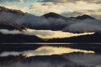 Sunrise with reflections and alpenglow in Lake Heiterwanger See in Tyrol in the Alps in Austria