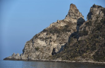 Steep rock formations on the edge of the blue sea under a clear sky, Ricadi, Capo Vaticano