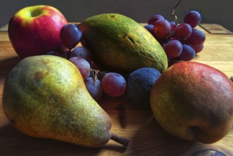 Colourful composition of pears, grapes and apples on a wooden table, Willich, North