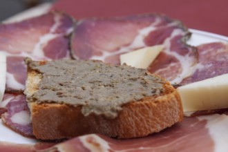 Crostini with liver cream, ham, sausage and cheese platter, Montalcino, Tuscany, Italy