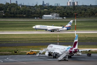 Düsseldorf Airport, Eurowings Airbus aircraft on the apron, SunExpress Boeing 737-800 taking off,
