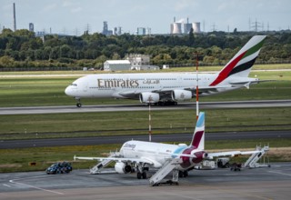 Düsseldorf Airport, Eurowings Airbus aircraft on the apron, Emirates Airbus A380-800 taking off, in