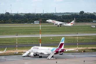 Düsseldorf Airport, Eurowings Airbus aircraft on the apron, German Airways Embraer ERJ-190 taking