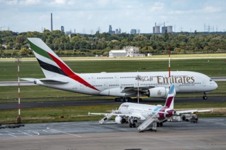 Düsseldorf Airport, Eurowings Airbus aircraft on the apron, Emirates Airbus A380-800 on its way to