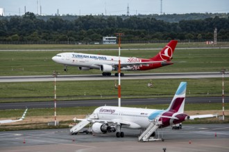 Düsseldorf Airport, Eurowings Airbus aircraft on the apron, Turkish Airlines Airbus A330-200 taking