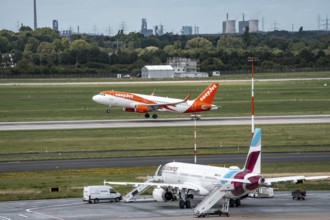 Düsseldorf Airport, Eurowings Airbus aircraft on the apron, EasyJet Airbus A320-200 taking off, in