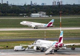 Düsseldorf Airport, Eurowings aircraft taking off, Eurowings Airbus on the apron, skyline of the
