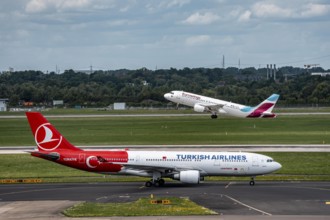 Düsseldorf Airport, Eurowings Airbus on take-off, Turkish Airlines Airbus A330-200 on the taxiway