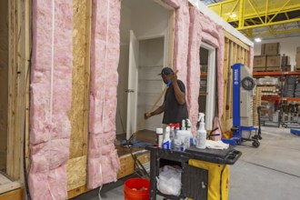 Romulus, Michigan - Workers build apartments in Ginosko Modular 's factory using modular