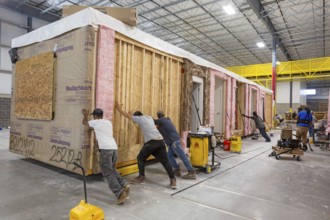 Romulus, Michigan - Workers build apartments in Ginosko Modular 's factory using modular