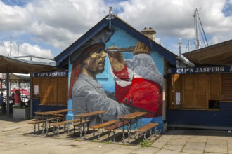 Pirate mural painted on wall at Cap'n Jaspers cafe, The Barbican, Plymouth, Devon, England, UK