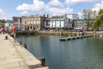 People sitting outside The Three Crowns pub quayside harbour, The Barbican, Plymouth, Devon,