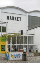 People at entrance door of Market Building or Pannier Market, city of Plymouth, Devon, England, UK