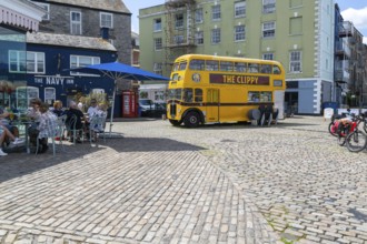 The Clippy yellow double-decker bus, The Barbican, Plymouth, Devon, England, UK