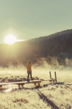 Young woman at Lake Staz near Sankt Moritz in the Engadine in Switzerland. Morning atmosphere with