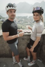 Young man taking a coffee break while riding his racing bike on Lake Garda. Sunny weather and dolce
