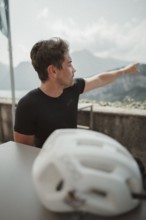 Young man riding a racing bike on Lake Garda. Sunny weather and dolce vita
