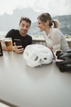 Woman and man cycling on Lake Garda in Italy. Sunny weather and dolce vita