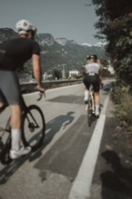 Woman and man riding racing bikes in Italy on Lake Garda