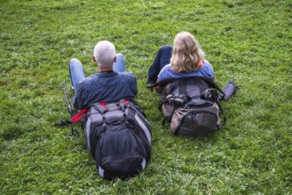 Couple resting in the grass, Interlaken, Bern, Switzerland