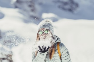 Woman in wintry surroundings in the Engadine in Switzerland