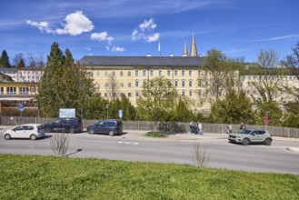 Royal Castle Berchtesgaden, general development, lawn, parking lane with vehicles, wooden fence,