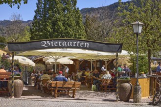 Beer garden, entrance, outdoor area of a restaurant with parasols, tables and benches, lantern,