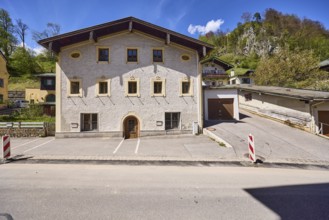 Historic building, garage, facade, window, door, mountain landscape, hill, forest, barrier beacons,