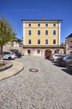 Town hall, general architecture, car park, vehicles, square, cobblestones, tree, blue sky,