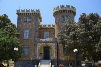 Bellinis Tower, Museum, Historical building with battlements and towers in front of a blue sky,