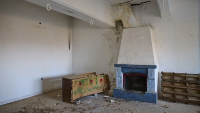 Lost Place, Apitiki, Military post, An empty room with a fireplace and neglected furniture, Photos