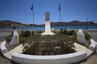 War memorial, A memorial with geometric shape, two flags and view of the sea and mountains, photos