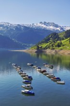 Motorboats moored at the reservoir, snow-covered Alps in the background, Lake Wägital, Canton