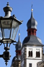 Historic alleyway lamp in front of the steeples of the Namen-Jesu-Kirche in Bonngasse, Bonn, North