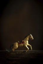 A vintage toy horse appears to be in motion, showcasing intricate details and a nostalgic design.