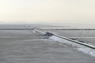 North Sea coast, cloudy winter day, Wadden Sea at low tide, stone groynes as coastal protection,