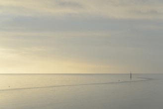 Wadden Sea at rising water, stone groyne with sea mark, North Sea, Norddeich, Lower Saxony, Germany
