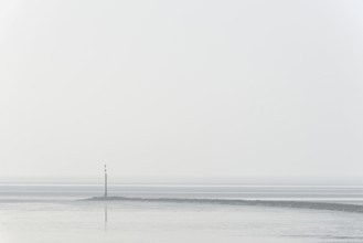 North Sea coast, cloudy winter day, Wadden Sea at low tide, stone groyne with sea mark, North Sea,
