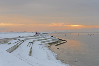 Evening atmosphere on the snow-covered beach promenade of Norddeich, North Sea, Lower Saxony,