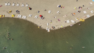 Aerial view of people relaxing on the beach. Sunbathing on the seashore