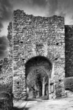 Léotoing village. An old stone archway showcases weathered stones and intricate designs, Haute