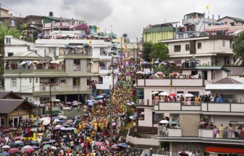 People from the Pnar community emjoy the Behdienkhlam festival from rooftop in Jowai, India on July