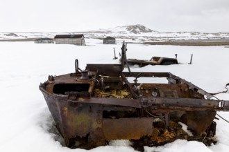 Former research station, rusty vehicle, wooden hut, Kinvika, Muchinsonfjord, Spitsbergen, Svalbard