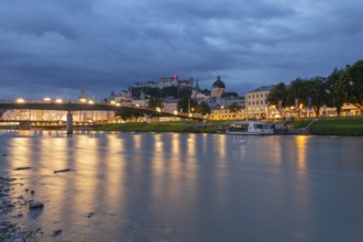 The city of Salzburg with the Salzach shines in the first light of summer morning