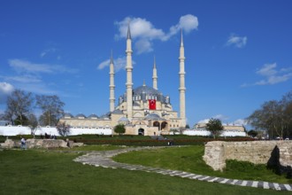Mosque with four high minarets, surrounded by green spaces under a clear blue sky, Selimiye Mosque,