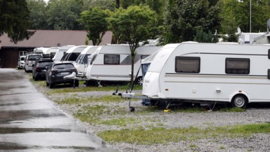Rainy summer day on a campsite, caravans standing next to each other in cloudy wet weather,