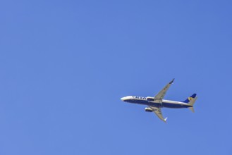 Ryanair passenger plane flying in a blue sky, Mallorca, Spain