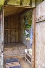 Interior in an old idyllic wooden outhouse for two people in the countryside, Sweden