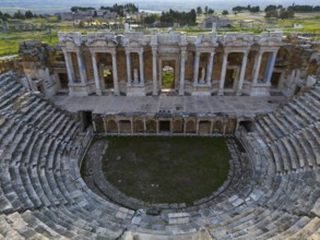 A well-preserved ancient theatre with stone tiers and an impressive façade, amphitheatre, aerial